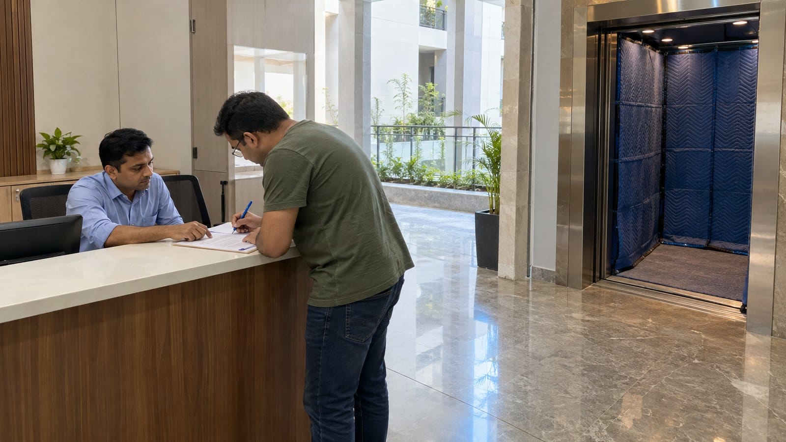 A resident fills in a shifting request at a tower maintenance desk beside a padded service lift