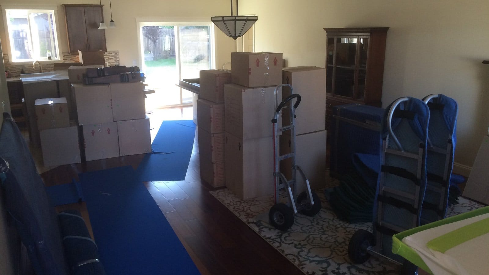A living room filled with packed cartons and furniture, ready for a move