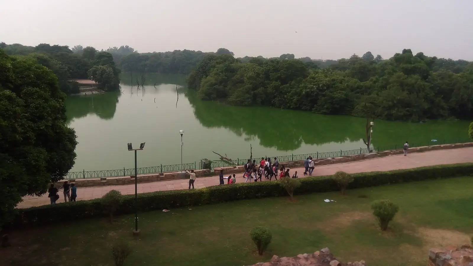 Illustration: hauz Khas lake and its lakeside walkway seen from the Hauz Khas fort ruins.