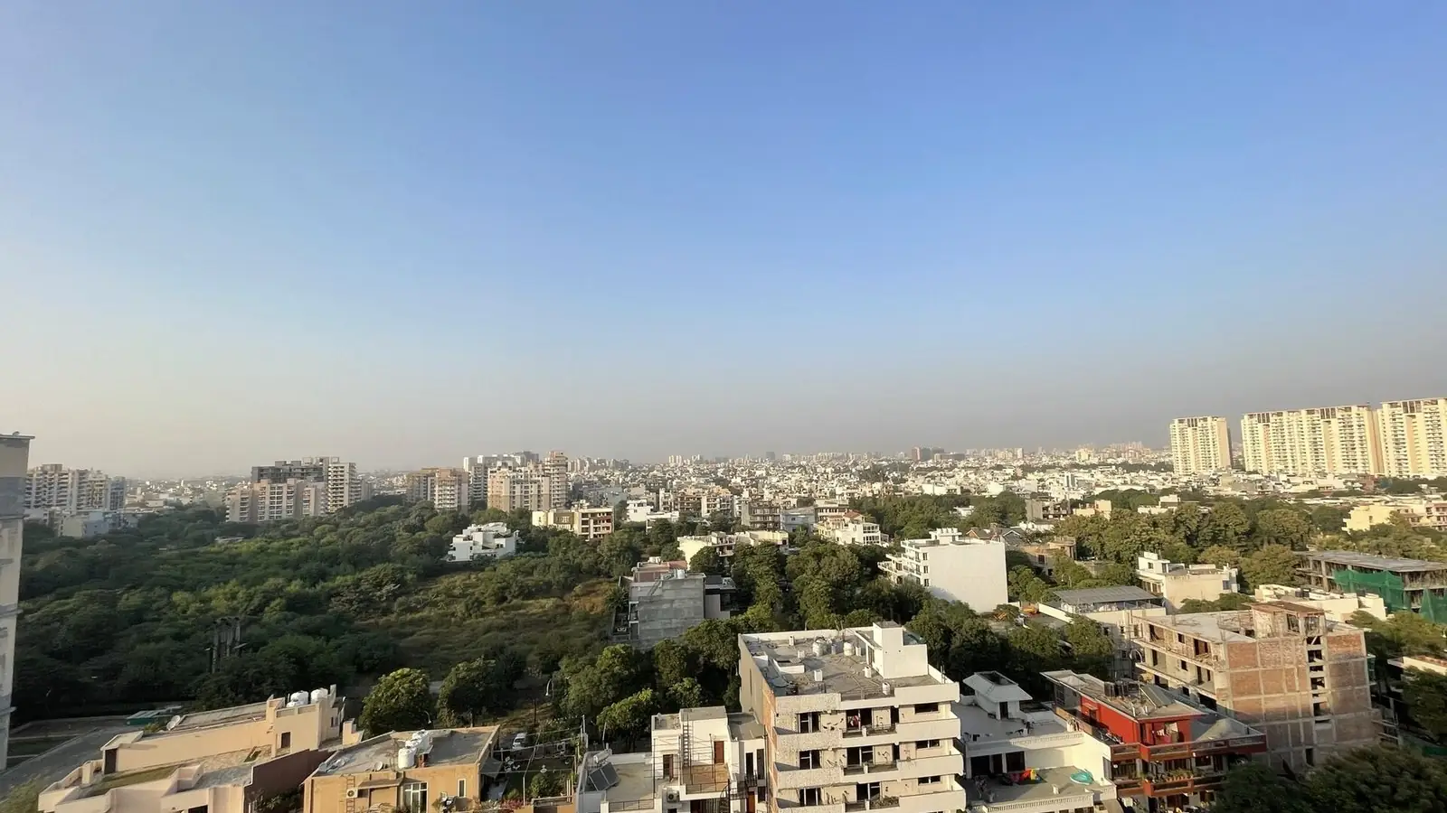 Illustration: rooftop view over the low-rise homes and tower blocks of Sector 47 off Sohna Road.