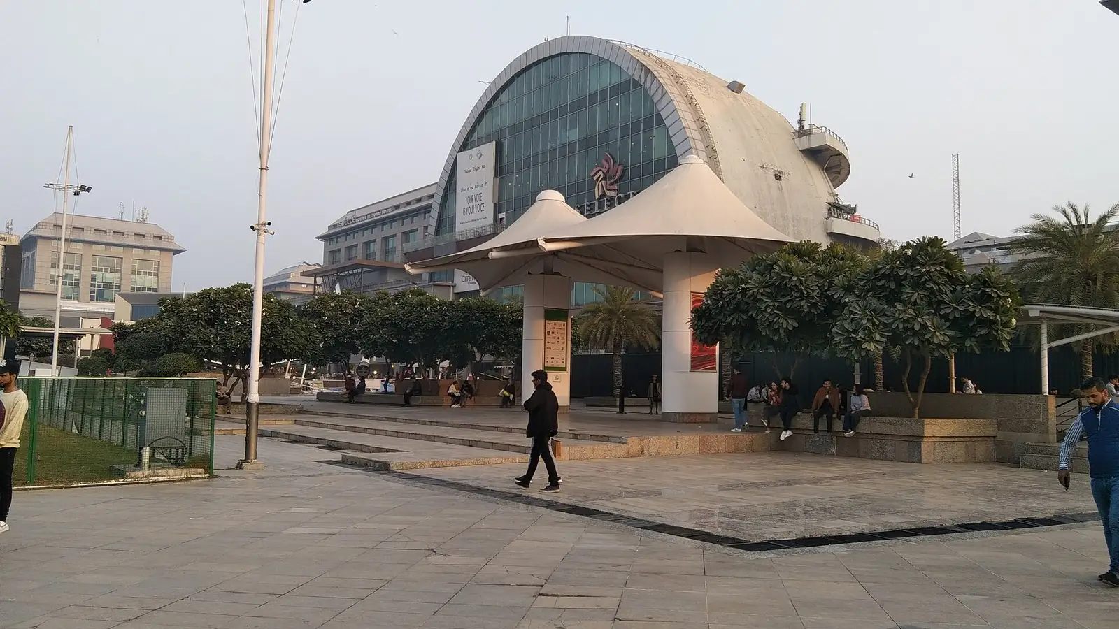 Illustration: the domed glass front and open plaza of Select Citywalk mall in Saket District Centre.