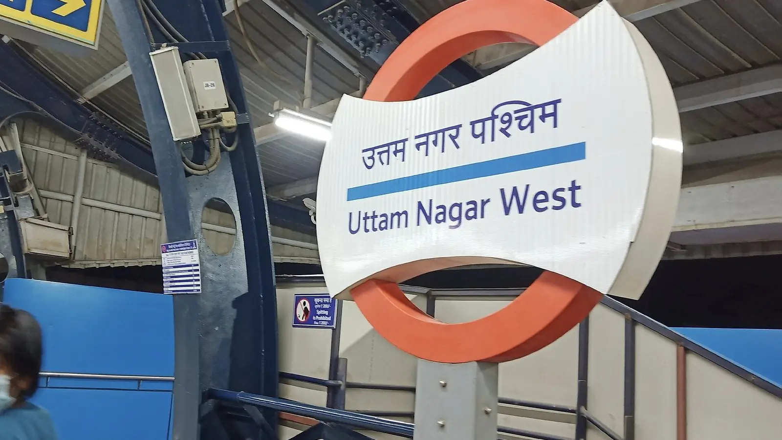 Illustration: station roundel on the platform of Uttam Nagar West metro station on the Blue Line.